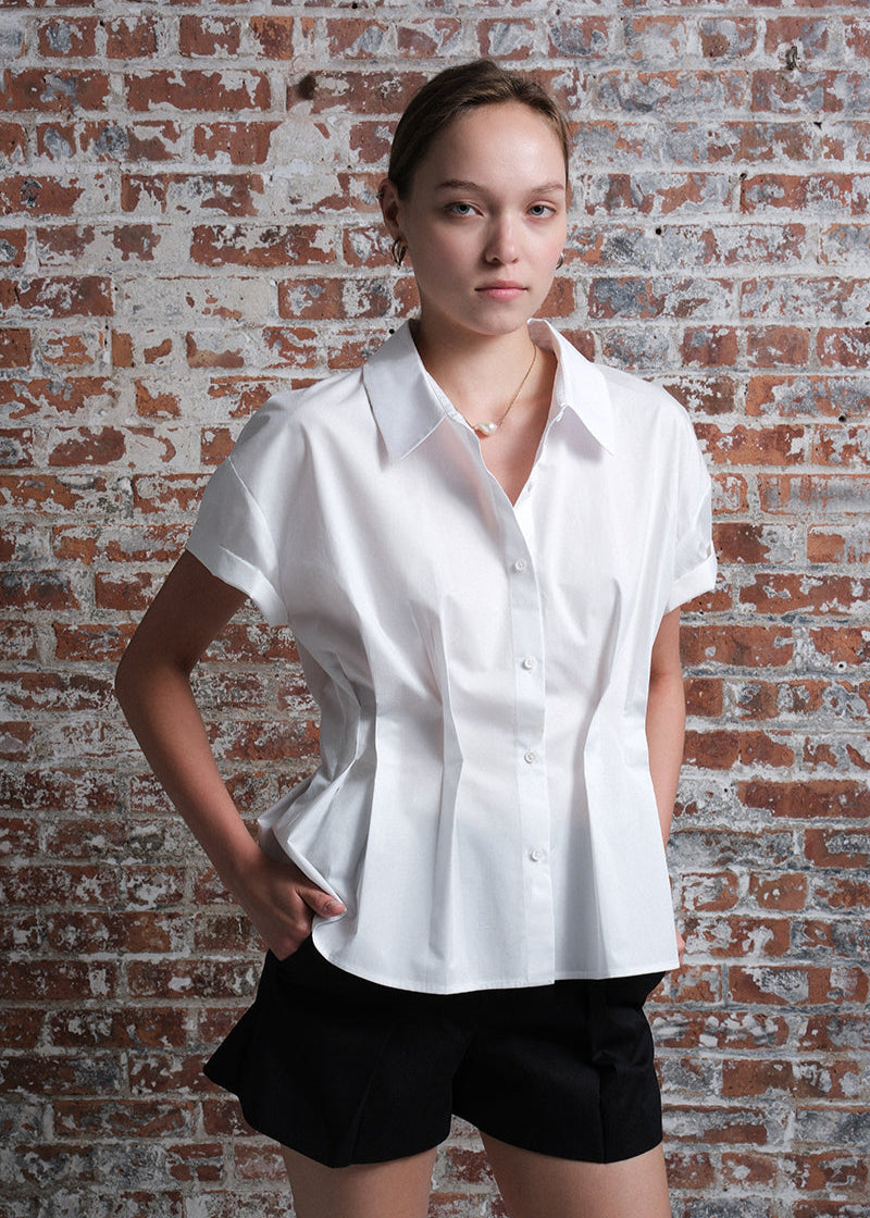 Women's short-sleeve white poplin shirt with a structured, tailored fit, front button closure, and wide collar.