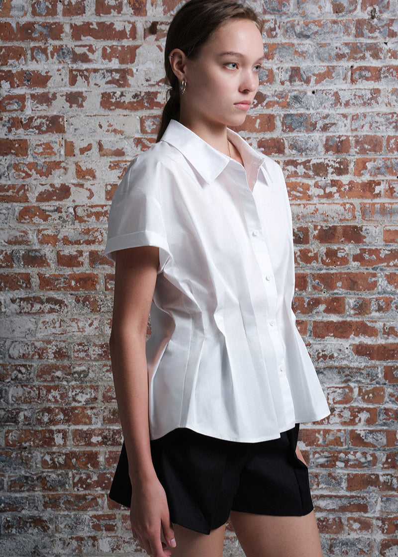 Women's short-sleeve white poplin shirt with a structured, tailored fit, front button closure, and wide collar.