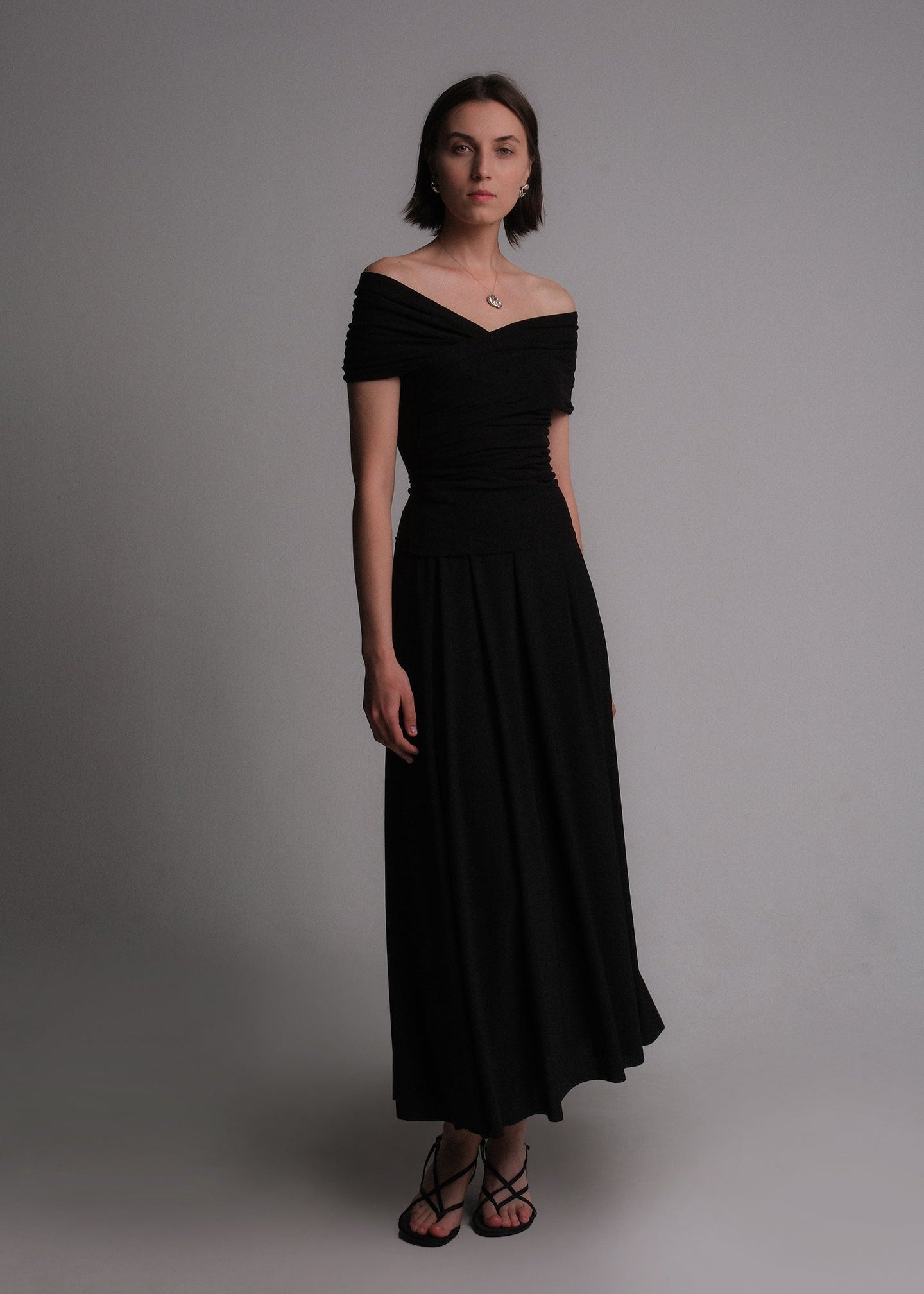 Women's off-the-shoulder black cotton-lyocell blend shirt featuring a draped, ruched design with a fitted silhouette.